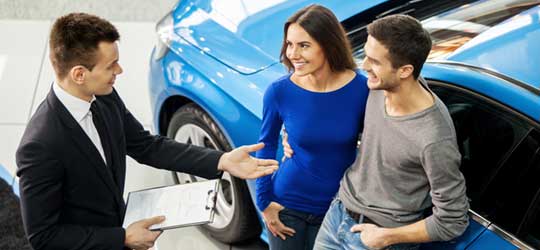 Couple buying at dealership